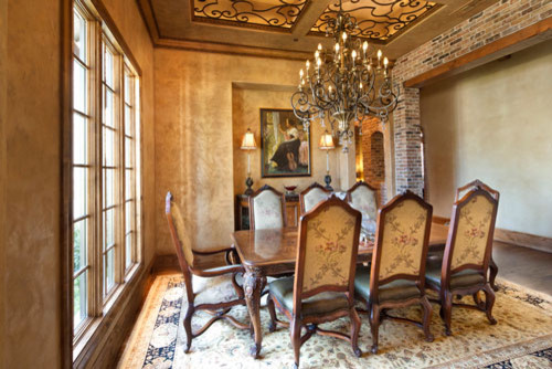 Photo of a mid-sized mediterranean separate dining room in Dallas with beige walls, medium hardwood floors and no fireplace.