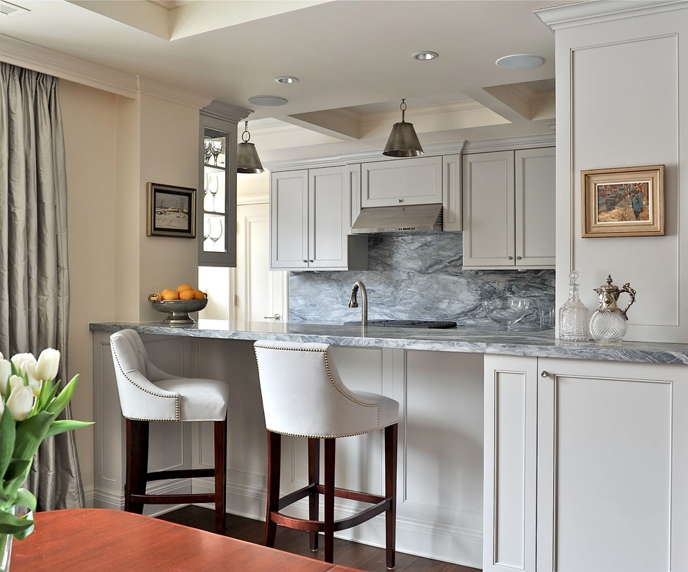 This is an example of a small kitchen in Montreal with recessed-panel cabinets, white cabinets and grey splashback.