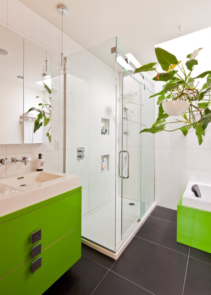Contemporary bathroom in Montreal with a vessel sink, flat-panel cabinets, green cabinets, a drop-in tub, a corner shower, white tile and ceramic floors.