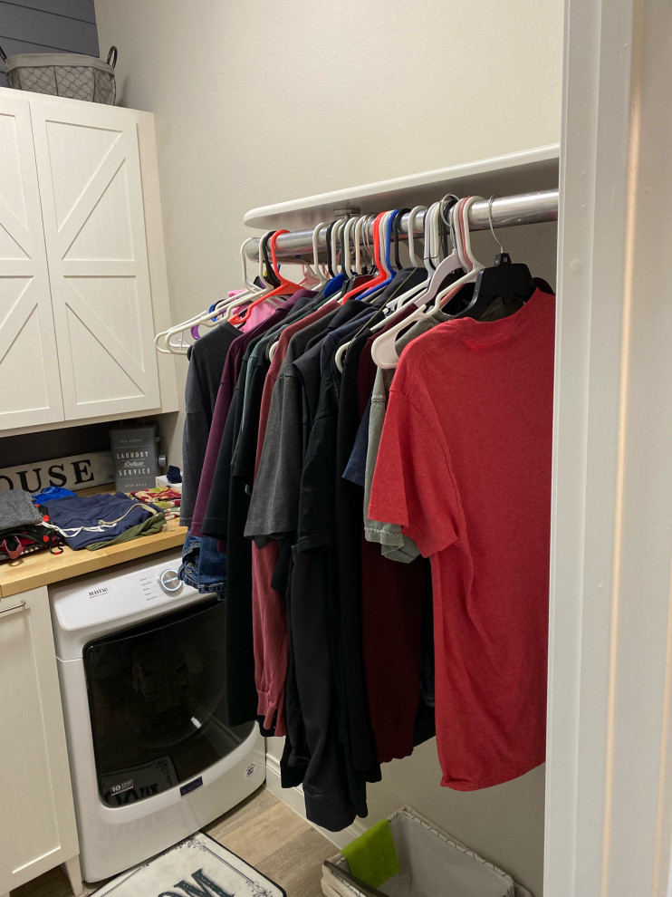 Mid-sized country single-wall dedicated laundry room in Austin with beaded inset cabinets, white cabinets, wood benchtops, grey walls and a side-by-side washer and dryer.