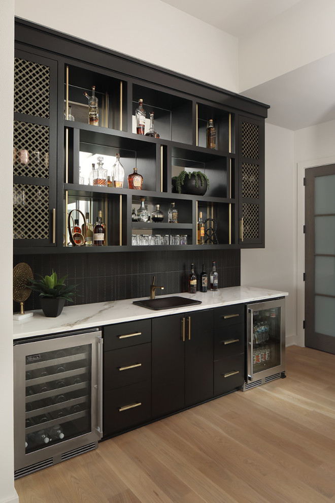 Wet bar - huge 1960s single-wall porcelain tile and gray floor wet bar idea in Milwaukee with an undermount sink, flat-panel cabinets, black cabinets, concrete countertops, black backsplash, glass tile backsplash and black countertops