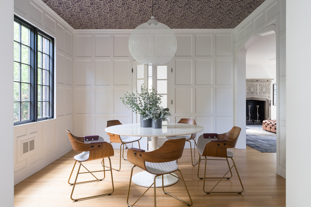 Transitional separate dining room in Boston with white walls and light hardwood floors.