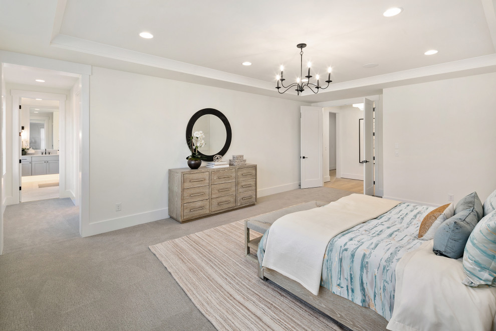 Example of a mid-sized farmhouse master light wood floor, beige floor and tray ceiling bedroom design in Seattle with white walls