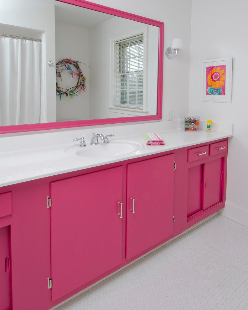 Example of a transitional bathroom design with pink cabinets