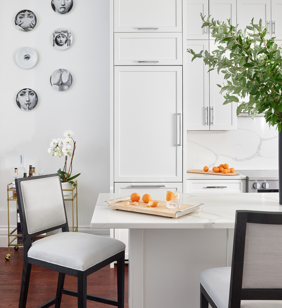 Mid-sized transitional u-shaped eat-in kitchen photo in Boston with quartzite countertops, white backsplash, an island and white countertops