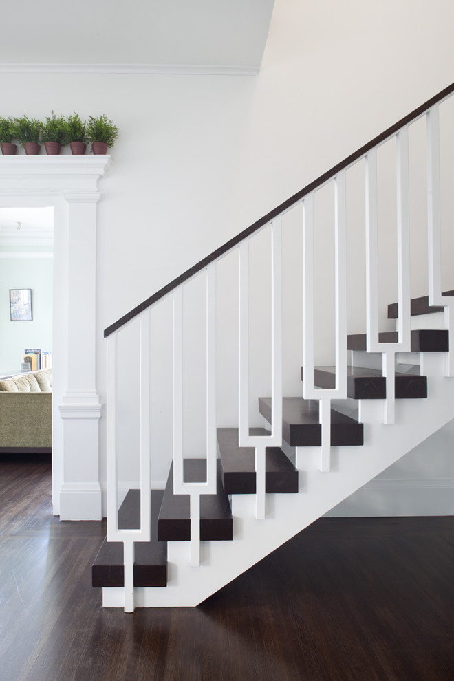 Photo of a transitional wood straight staircase in San Francisco with open risers and mixed railing.