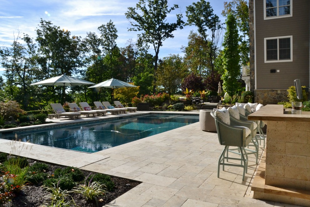 Hot tub - large backyard stone and custom-shaped lap hot tub idea in New York