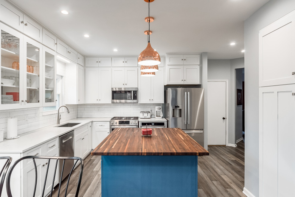 Eat-in kitchen - mid-sized transitional l-shaped eat-in kitchen idea in Columbus with shaker cabinets, quartz countertops, white backsplash, subway tile backsplash and an island