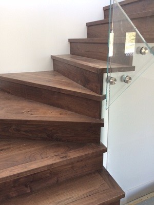 Staircase - transitional wooden staircase idea in Calgary with wooden risers