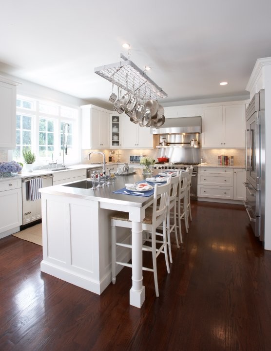 Example of a large transitional u-shaped dark wood floor eat-in kitchen design with shaker cabinets, white cabinets, stainless steel countertops, white backsplash, stainless steel appliances and an island