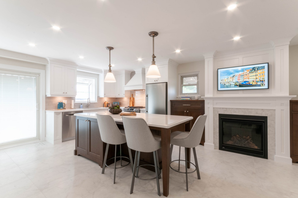 Eat-in kitchen - large transitional l-shaped porcelain tile and white floor eat-in kitchen idea in Toronto with an undermount sink, recessed-panel cabinets, white cabinets, quartz countertops, gray backsplash, ceramic backsplash, stainless steel appliances, an island and white countertops