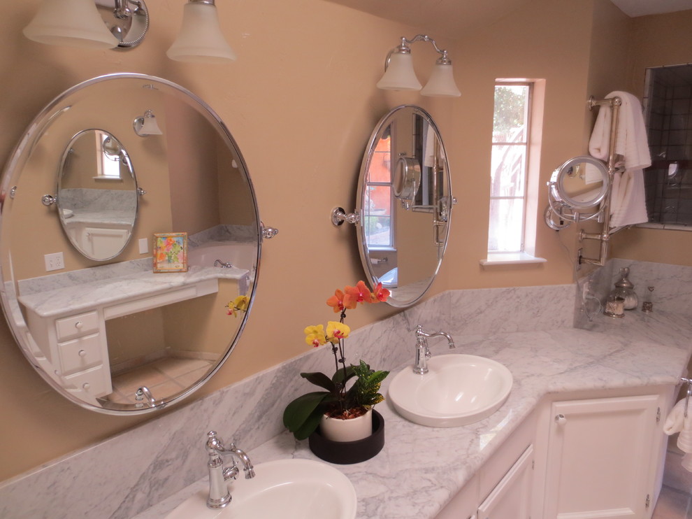 Inspiration for a contemporary master drop-in bathtub remodel with flat-panel cabinets, white cabinets and marble countertops