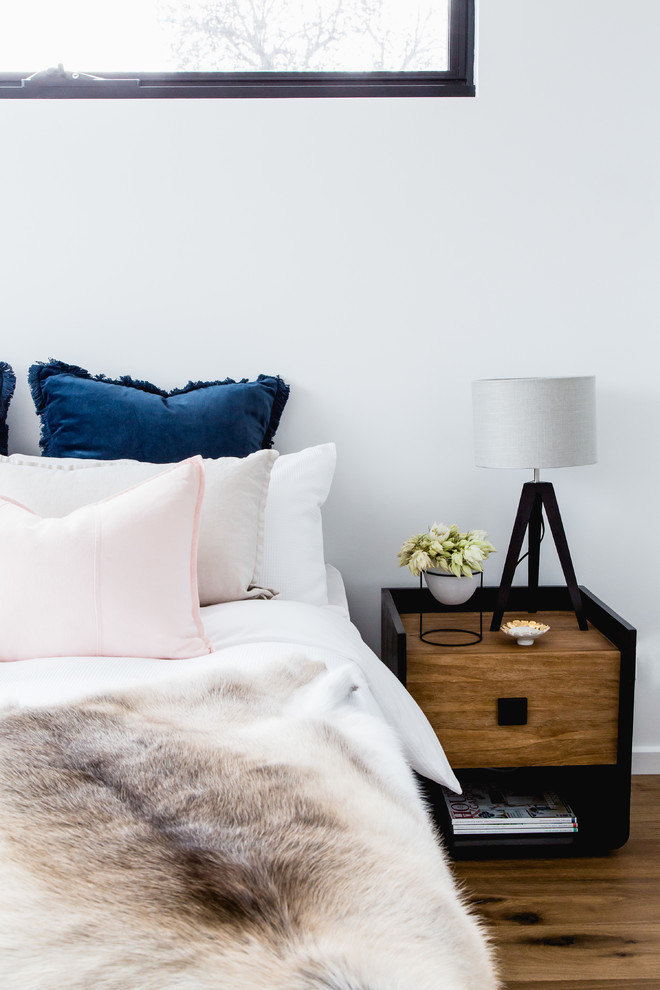 Inspiration for a mid-sized contemporary master bedroom in Melbourne with white walls and light hardwood floors.
