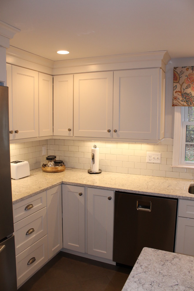 Inspiration for a large traditional l-shaped eat-in kitchen in Boston with an undermount sink, recessed-panel cabinets, white cabinets, granite benchtops, white splashback, subway tile splashback, stainless steel appliances, ceramic floors and with island.