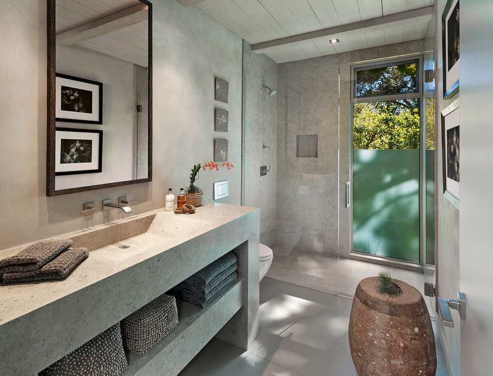 Inspiration for an expansive contemporary master bathroom in Santa Barbara with open cabinets, grey cabinets, grey walls, a freestanding tub, an open shower, porcelain floors, an integrated sink, engineered quartz benchtops and a hinged shower door.
