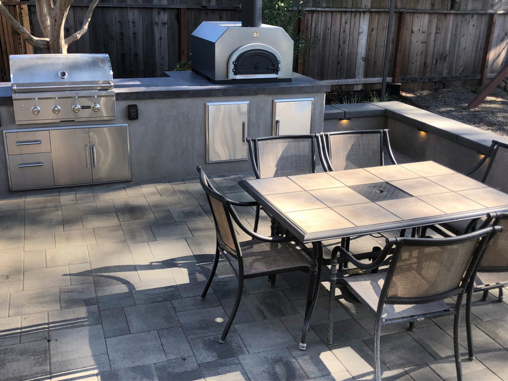 Mid-sized modern backyard patio in San Francisco with an outdoor kitchen, concrete pavers and no cover.