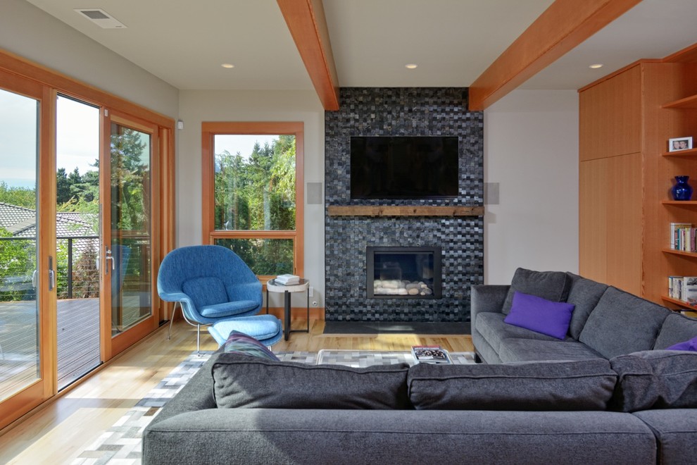 Photo of a contemporary living room in Seattle with a tile fireplace surround.