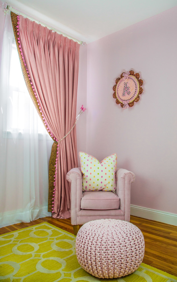 Inspiration for a mid-sized master bedroom in New York with pink walls, medium hardwood floors and no fireplace.