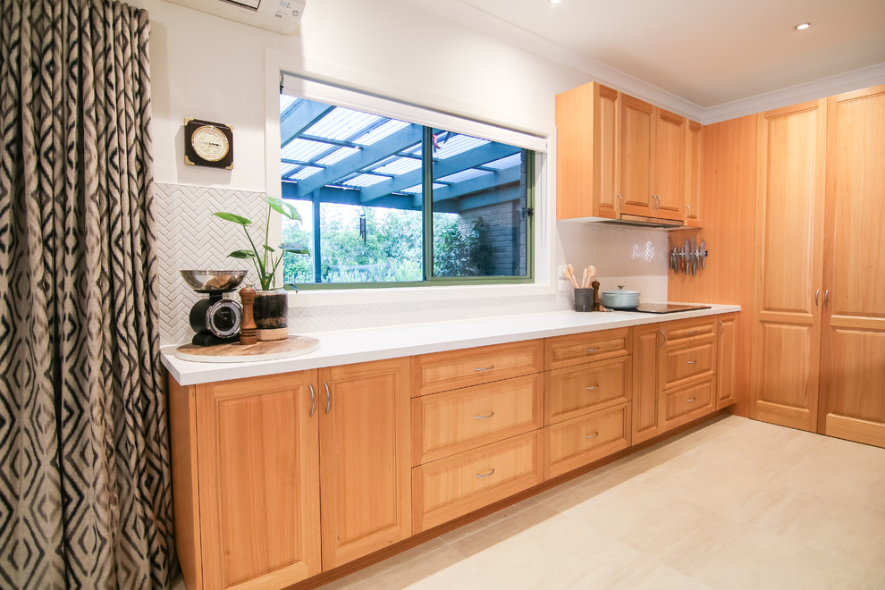 Photo of a large contemporary open plan kitchen in Melbourne with a double-bowl sink, white splashback, ceramic splashback, white appliances, ceramic floors and with island.