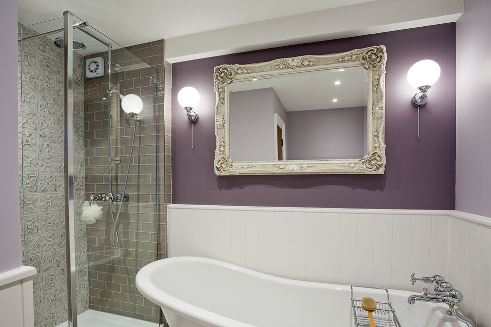 Inspiration for a mid-sized traditional kids bathroom in Sussex with shaker cabinets, white cabinets, a freestanding tub, a corner shower, a one-piece toilet, gray tile, ceramic tile, purple walls, porcelain floors, a trough sink, marble benchtops, grey floor and a hinged shower door.