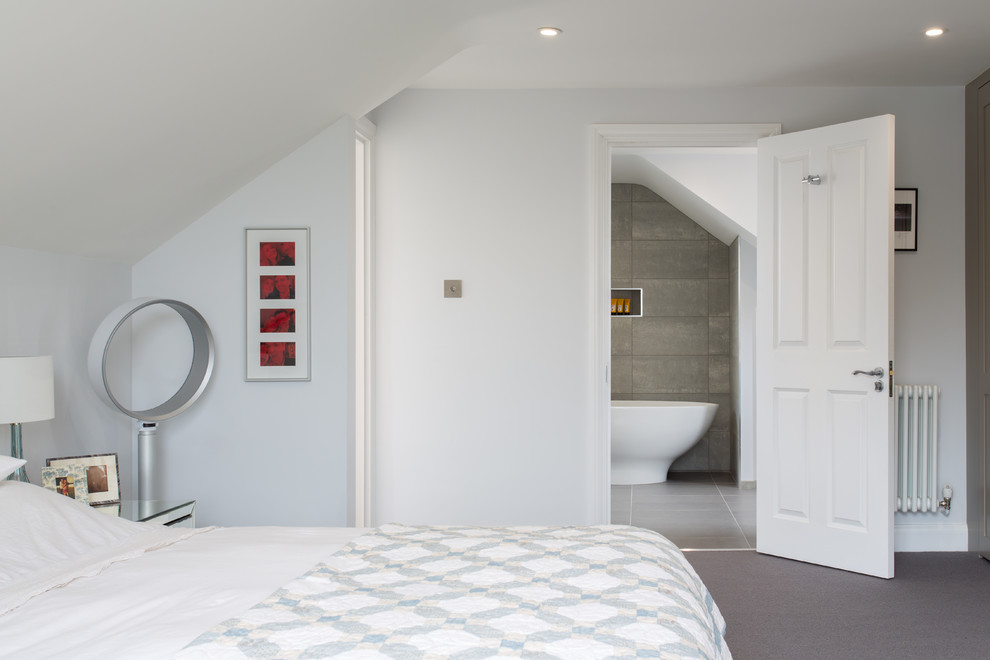 Design ideas for a medium sized modern master bedroom in London with grey walls, carpet and no fireplace.