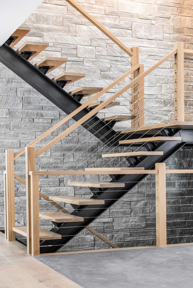 Contemporary wood staircase in Toronto with open risers and cable railing.