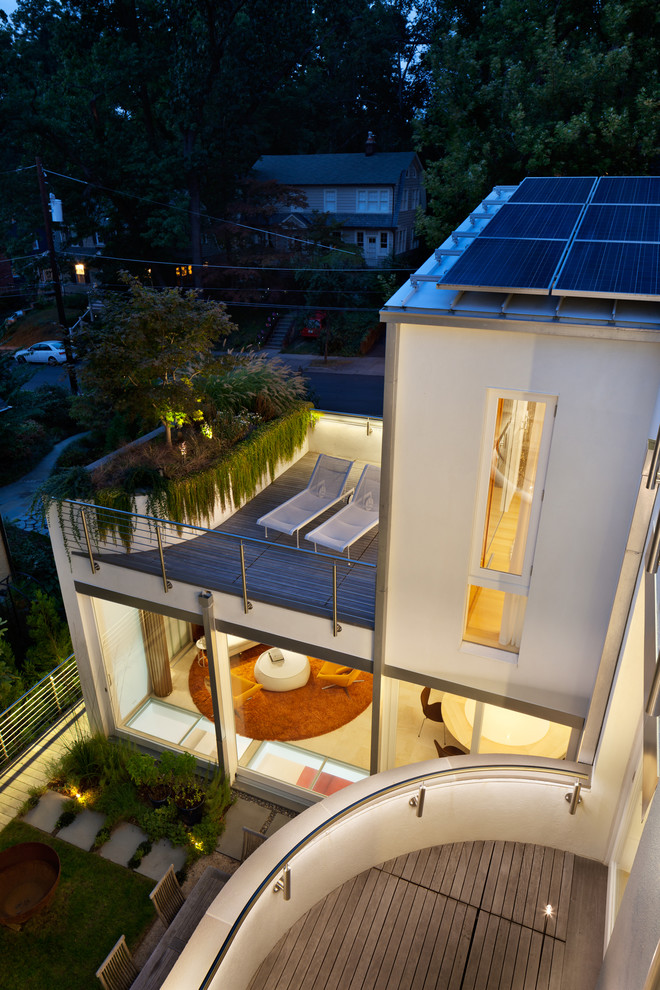 Example of a large trendy three-story stucco white deck design in DC Metro