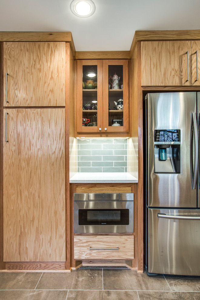 Mid-sized midcentury galley separate kitchen in Dallas with an undermount sink, flat-panel cabinets, medium wood cabinets, quartz benchtops, white splashback, glass tile splashback, stainless steel appliances, porcelain floors, no island and multi-coloured floor.