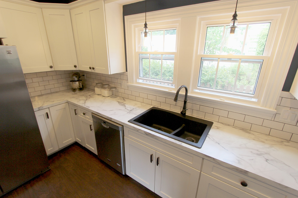This is an example of a mid-sized transitional galley kitchen pantry in Cleveland with an undermount sink, flat-panel cabinets, white cabinets, white appliances, linoleum floors and no island.