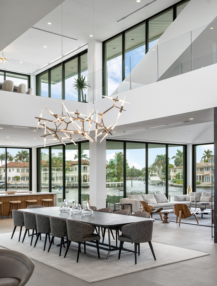 This is an example of an expansive contemporary kitchen/dining combo in Miami with white walls, ceramic floors and grey floor.