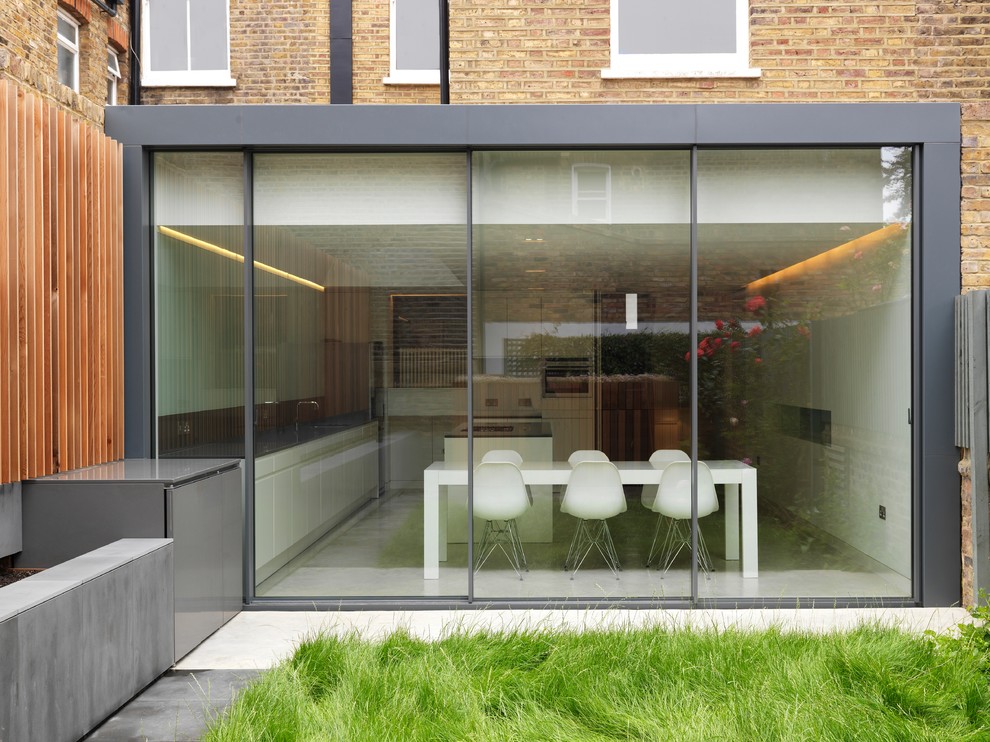 This is an example of a contemporary brick house exterior in London with a flat roof.