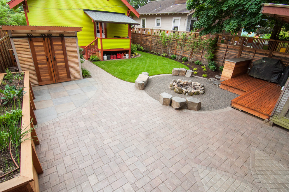 Inspiration for a small eclectic backyard garden in Portland with a fire feature and natural stone pavers.
