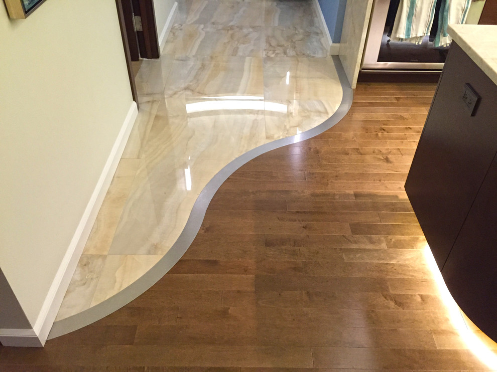Photo of a large contemporary hallway in Chicago with white walls and medium hardwood floors.