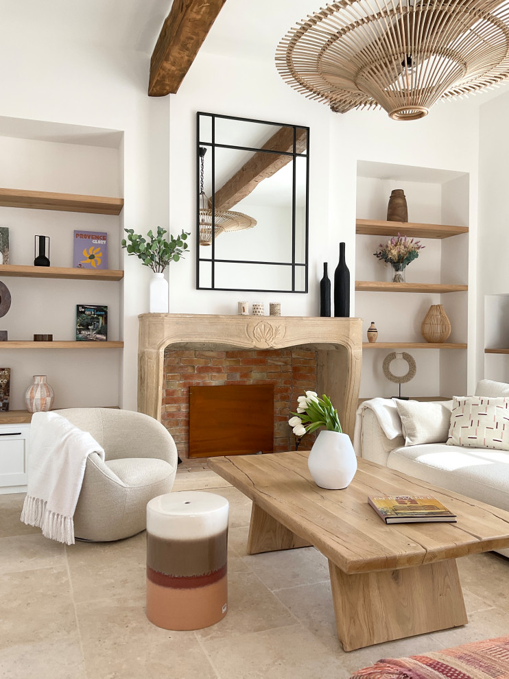 マルセイユにある高級な広い地中海スタイルのおしゃれなLDK (白い壁、トラバーチンの床、標準型暖炉、石材の暖炉まわり、テレビなし、ベージュの床、表し梁) の写真