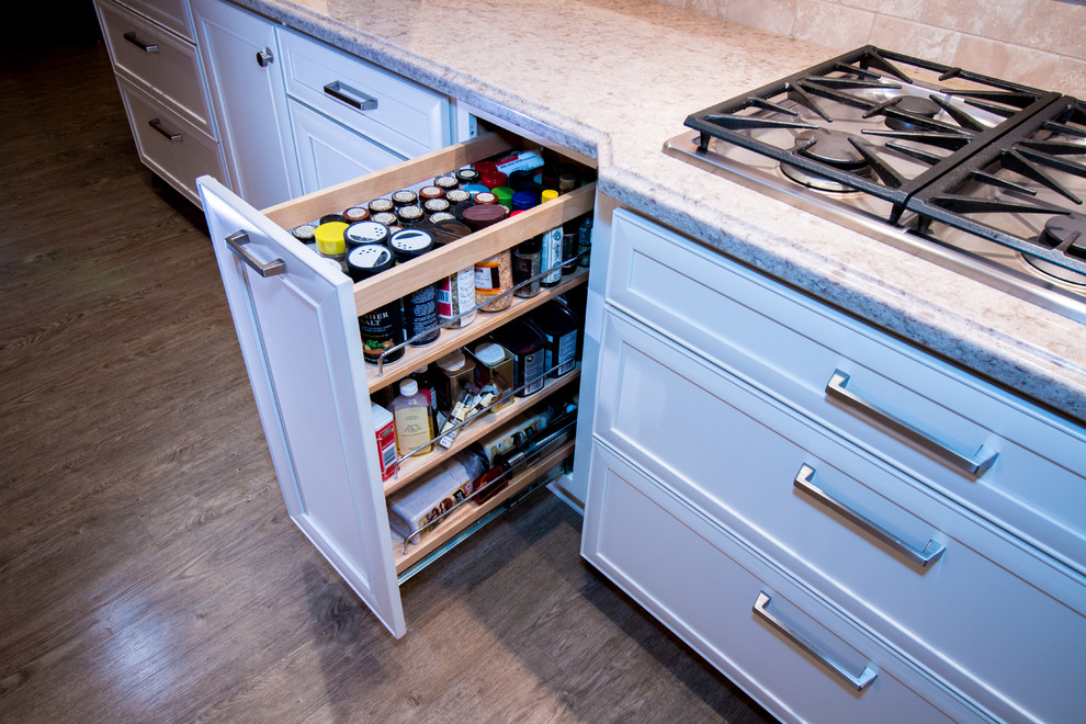 Example of a huge transitional open concept kitchen design with a farmhouse sink, recessed-panel cabinets, white cabinets, quartz countertops, beige backsplash, stone tile backsplash, stainless steel appliances and an island