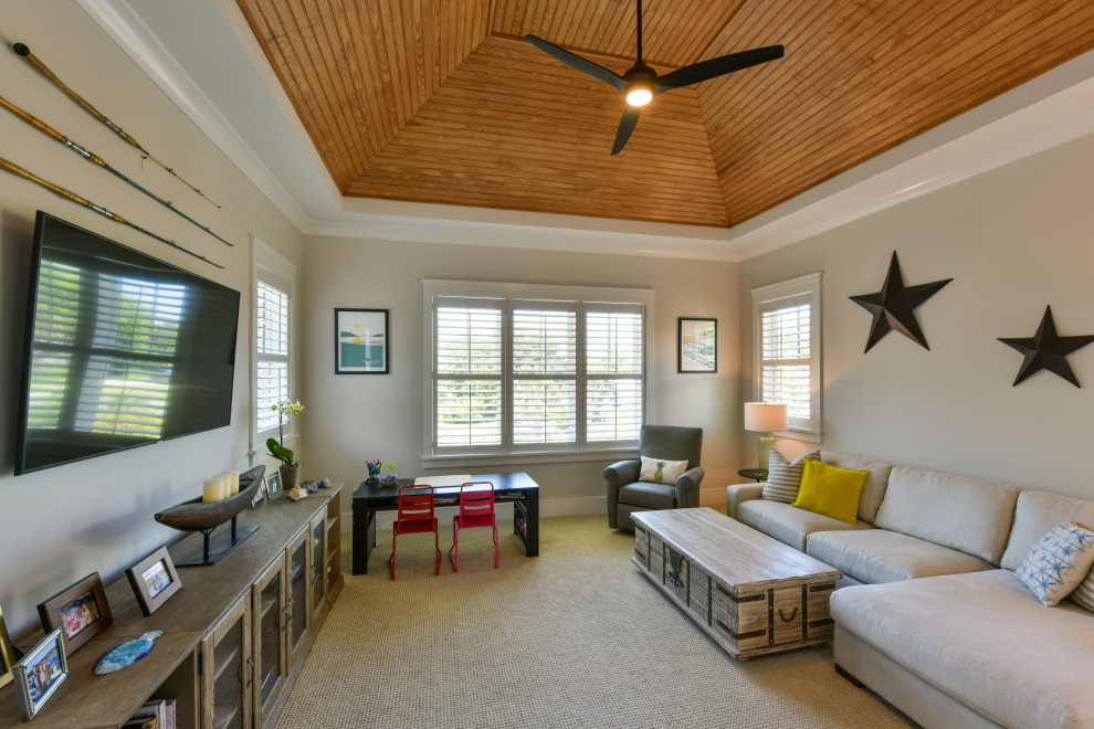This is an example of a beach style gender-neutral kids' room in Charleston with grey walls, carpet and timber.