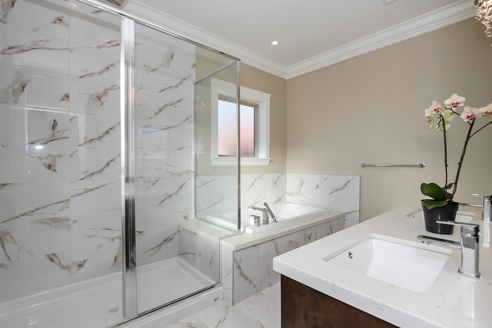 Mid-sized traditional master bathroom in Vancouver with an undermount sink, recessed-panel cabinets, dark wood cabinets, granite benchtops, a drop-in tub, a corner shower, a one-piece toilet, multi-coloured tile and beige walls.