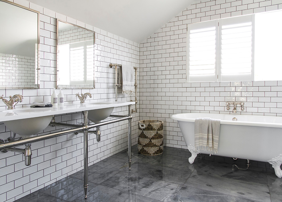 Design ideas for a traditional master bathroom in Auckland with a claw-foot tub, white tile, subway tile, white walls, a console sink and grey floor.