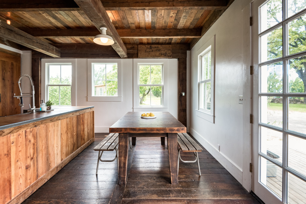 Country kitchen/dining combo in San Francisco with white walls, dark hardwood floors and brown floor.