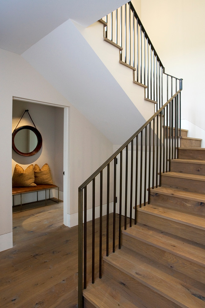 Example of a mountain style wooden l-shaped metal railing staircase design with wooden risers