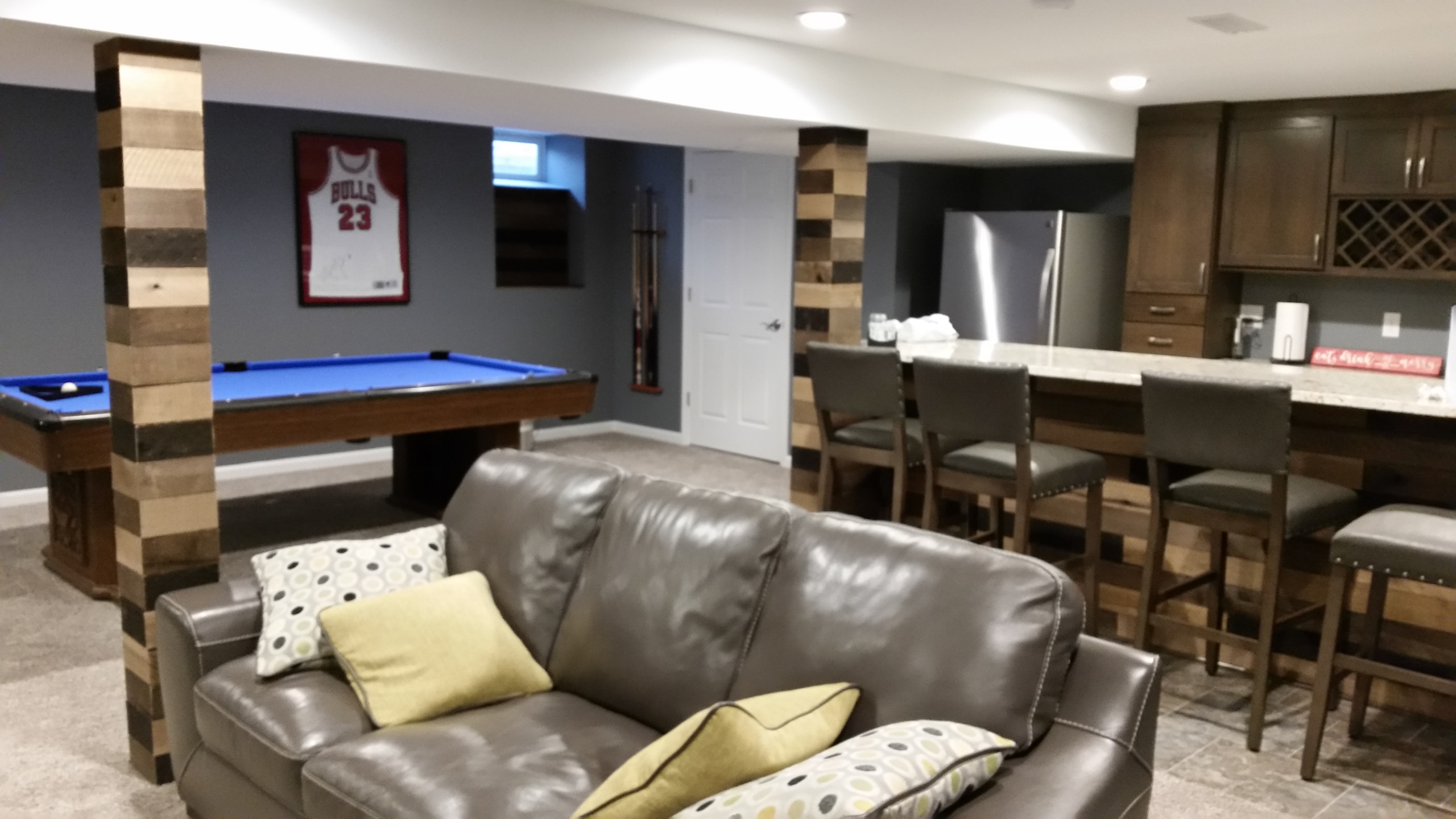 Basement rec room with custom bar and bedroom
