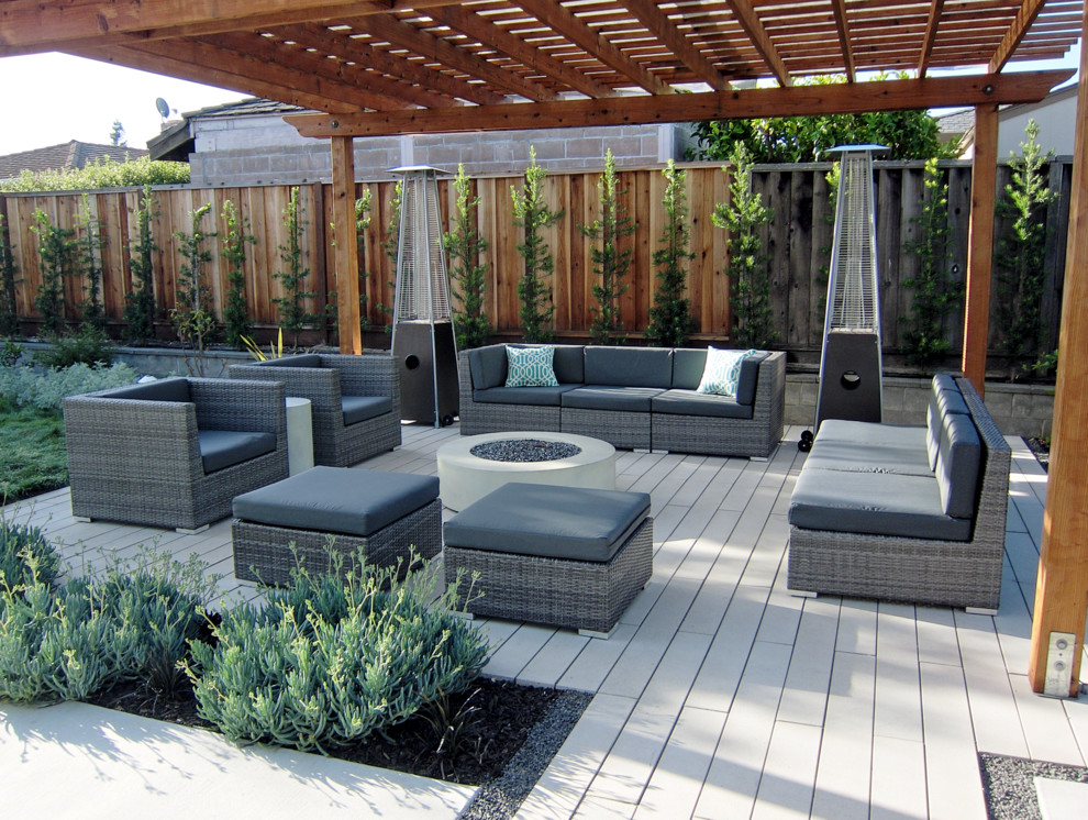 Inspiration for a mid-sized modern backyard full sun garden in San Francisco with concrete pavers and a fire feature.