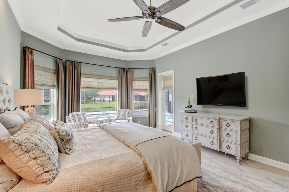 Design ideas for a large transitional master bedroom in Orlando with green walls, light hardwood floors and no fireplace.