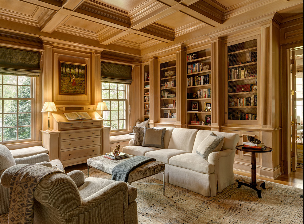 Photo of a large traditional home office in New York with a library and brown walls.