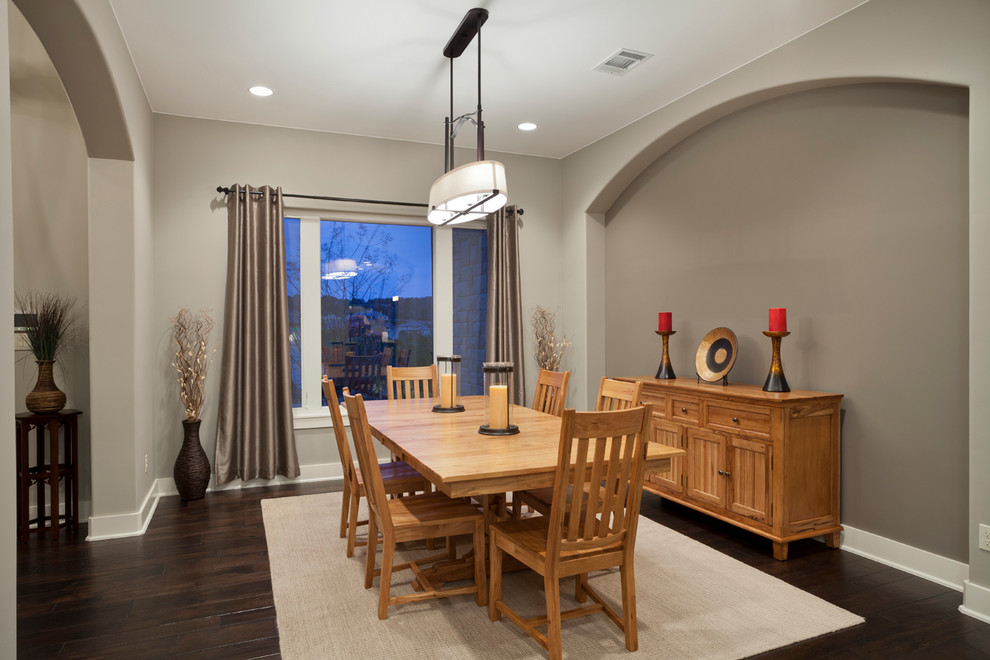 Photo of a transitional dining room in Austin with grey walls and dark hardwood floors.