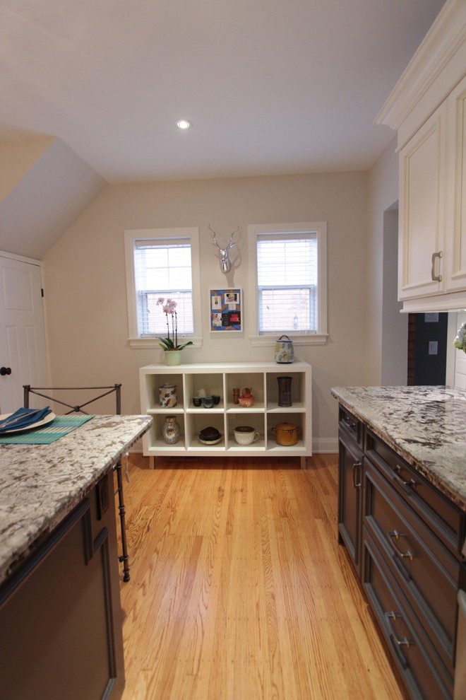 Photo of a mid-sized eclectic l-shaped separate kitchen in Toronto with an undermount sink, recessed-panel cabinets, light wood cabinets, granite benchtops, white splashback, subway tile splashback, stainless steel appliances, light hardwood floors and a peninsula.