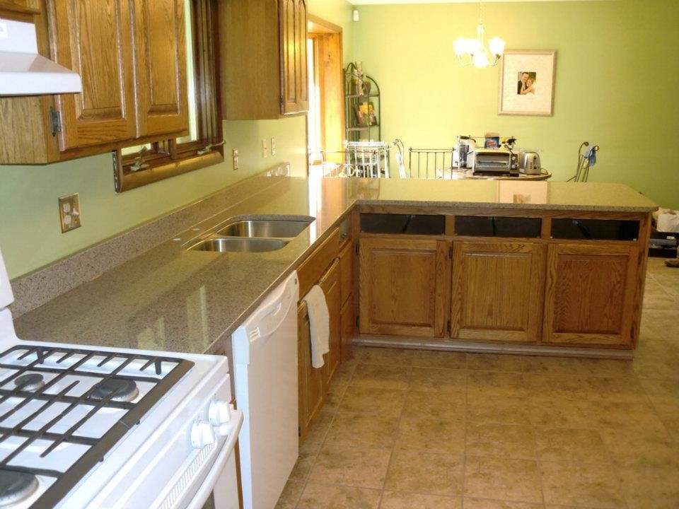 Inspiration for a transitional kitchen remodel in Chicago with an undermount sink, light wood cabinets and green backsplash