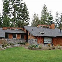 Example of a large minimalist wood exterior home design in Seattle