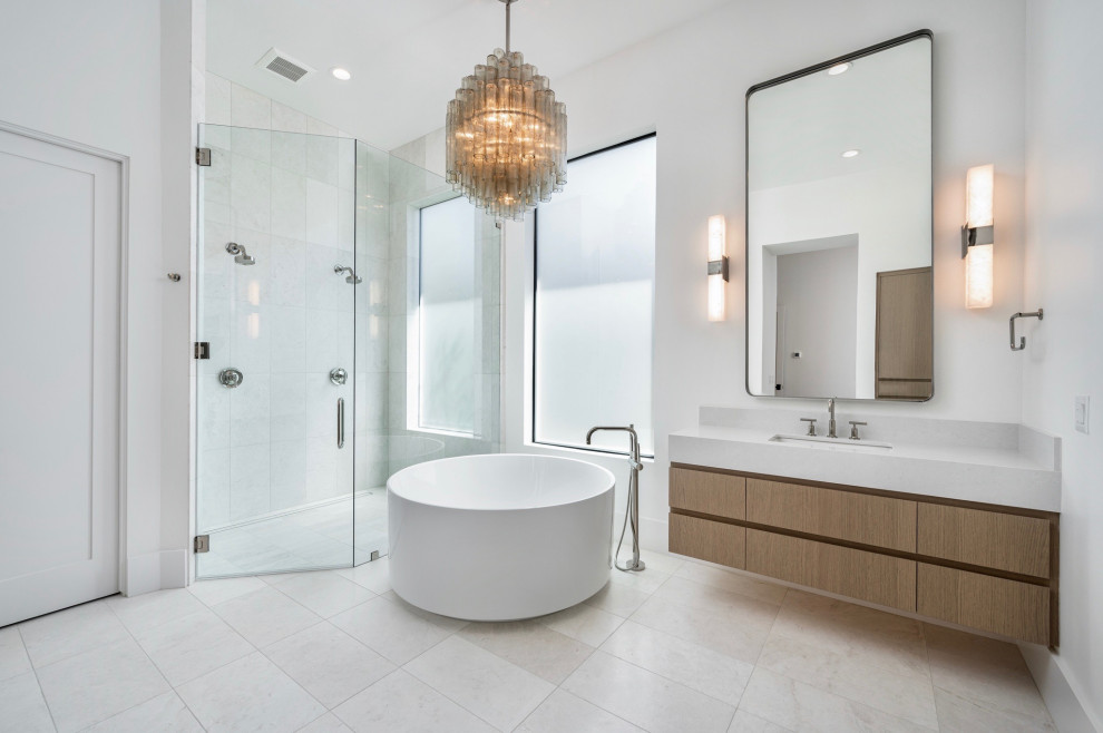 Photo of a large contemporary master bathroom in Phoenix with a curbless shower, marble, engineered quartz benchtops, a floating vanity, flat-panel cabinets, brown cabinets, white walls, an undermount sink, beige floor, a hinged shower door, grey benchtops, a single vanity and a japanese tub.