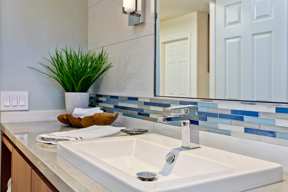 Inspiration for a mid-sized contemporary kids bathroom in Denver with an undermount sink, flat-panel cabinets, medium wood cabinets, quartzite benchtops, a shower/bathtub combo, a one-piece toilet, white tile, porcelain tile, grey walls and porcelain floors.
